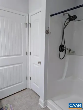 a bathroom with a glass shower door