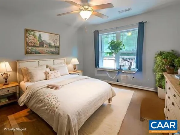 a spacious bedroom with a bed and a chandelier