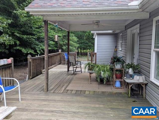 4489 Campbell Road Troy, VA 22974 - Photo 25 of 33 a view of a patio with table and chairs potted plants with wooden floor and fence