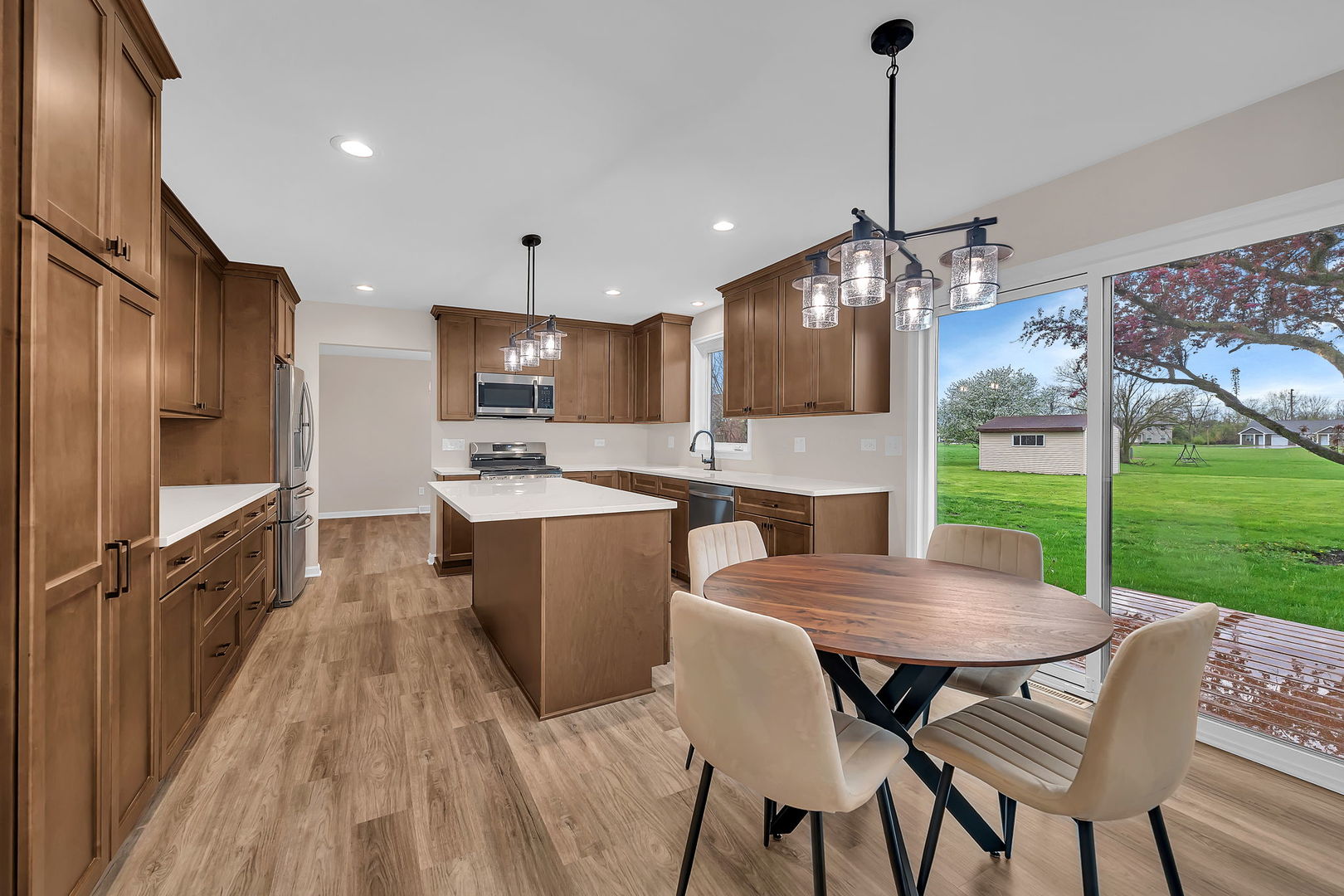 2380 Chestnut Lane Morris, IL 60450 - Photo 18 of 43 a kitchen with a table chairs refrigerator and microwave