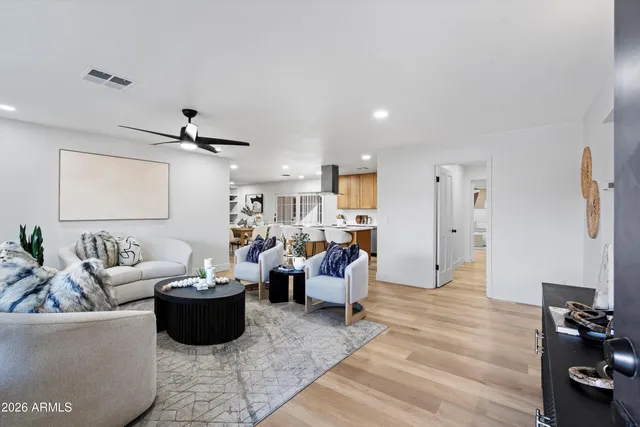 a living room with furniture and wooden floor