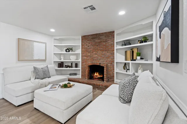a living room with furniture and a fireplace