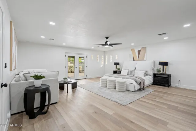 a bedroom with a bed and wooden floor