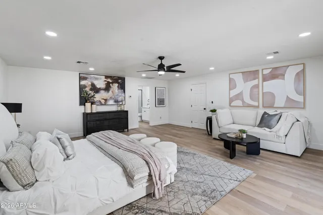 a spacious bedroom with a bed and furniture