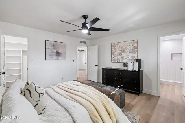 a bedroom with a bed and a chandelier