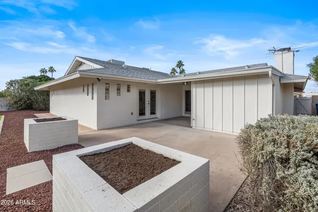 a view of a white house with a outdoor space