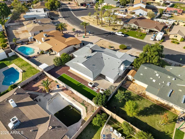 an aerial view of residential houses with outdoor space