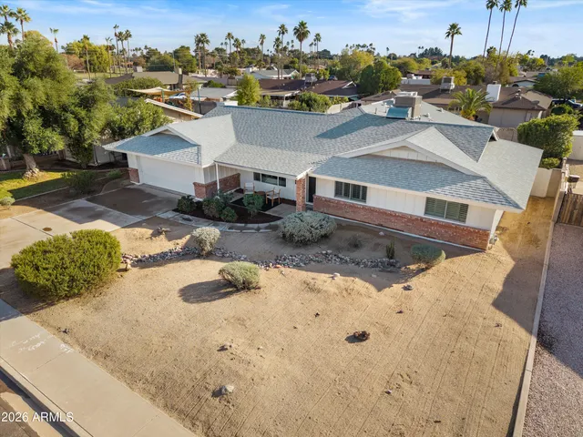 an aerial view of a house with a yard