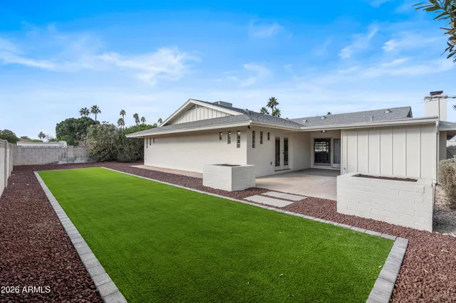 a front view of a house with a garden and yard