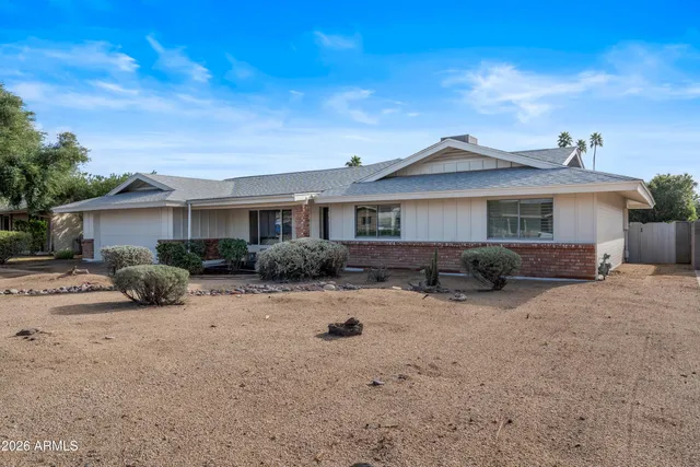 a view of a house with a yard covered in snow