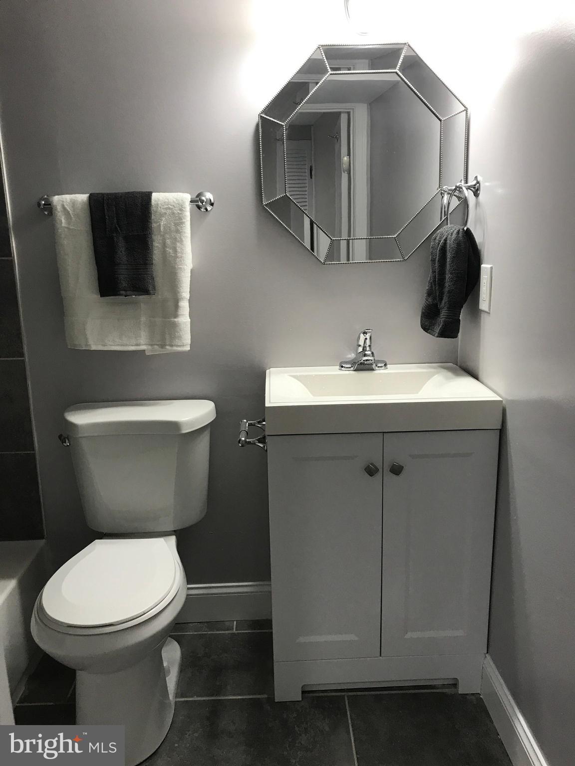 1441 Walker Avenue Baltimore, MD 21239 - Photo 12 of 28 a bathroom with a sink toilet and mirror