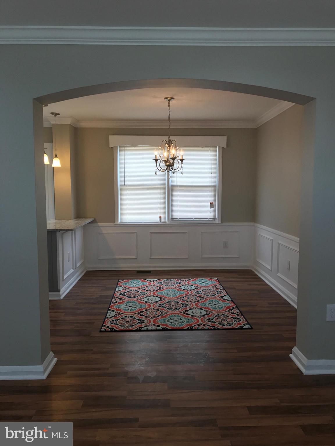 1441 Walker Avenue Baltimore, MD 21239 - Photo 17 of 28 a view of a hallway view with wooden floor and fireplace