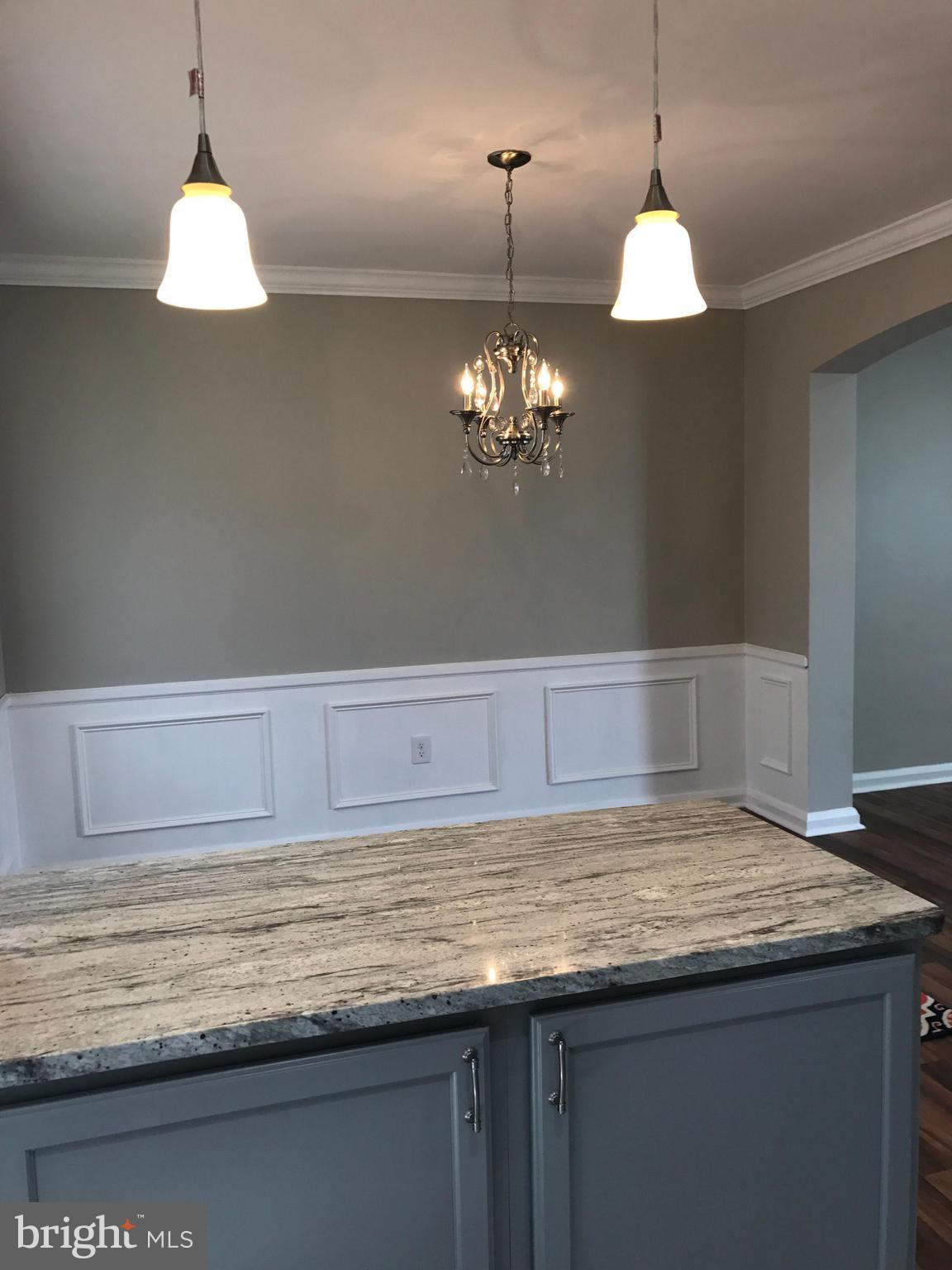 1441 Walker Avenue Baltimore, MD 21239 - Photo 19 of 28 a view of a kitchen with a sink and chandelier