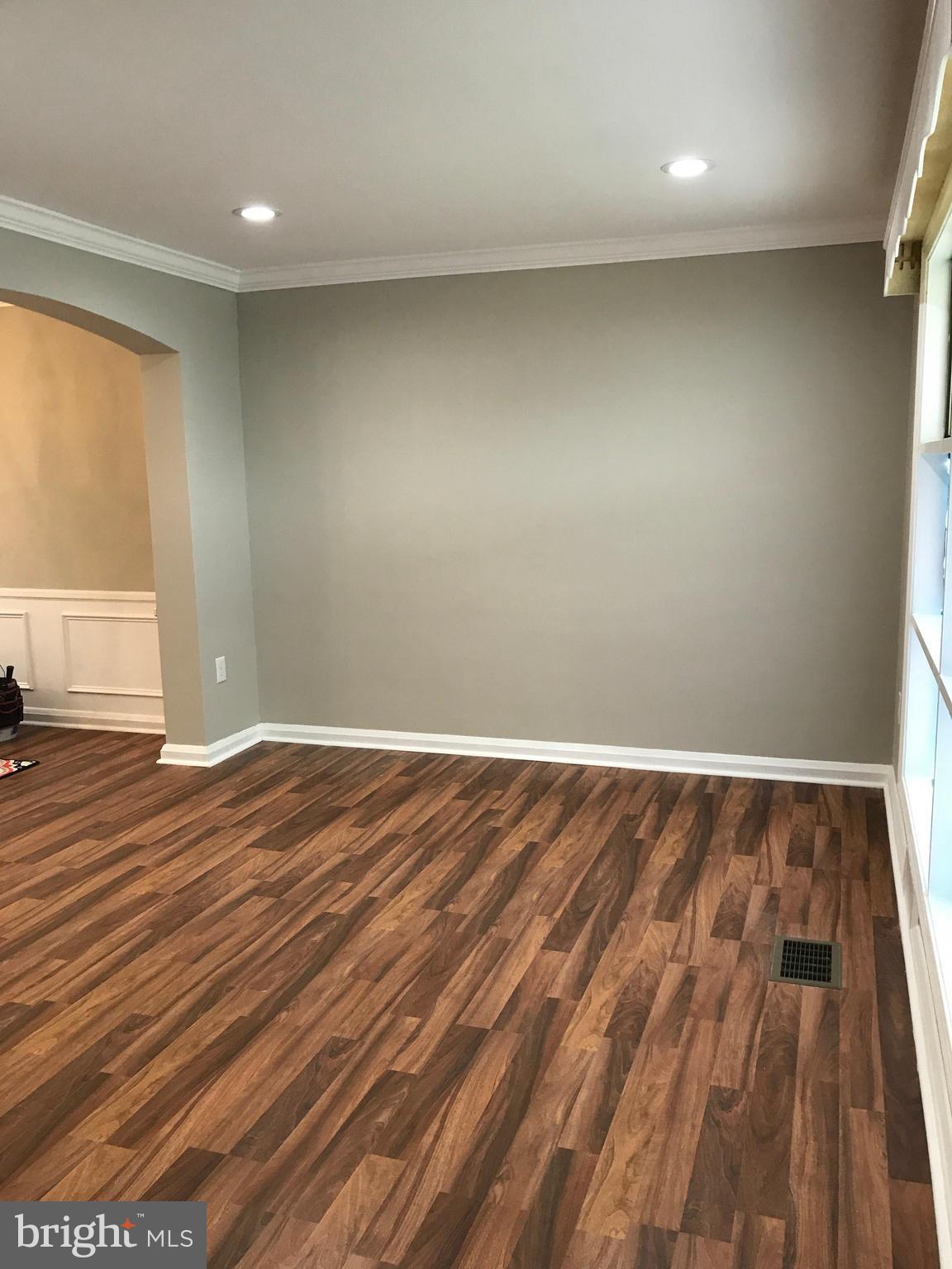 1441 Walker Avenue Baltimore, MD 21239 - Photo 20 of 28 an empty room with wooden floor and windows