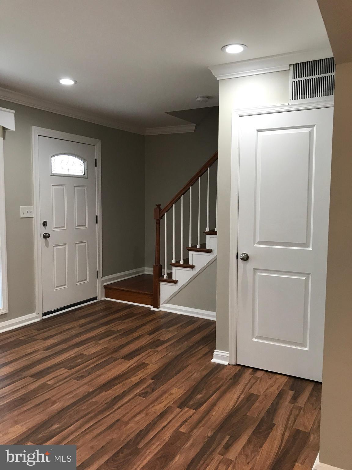 1441 Walker Avenue Baltimore, MD 21239 - Photo 23 of 28 an empty room with wooden floor & entryway