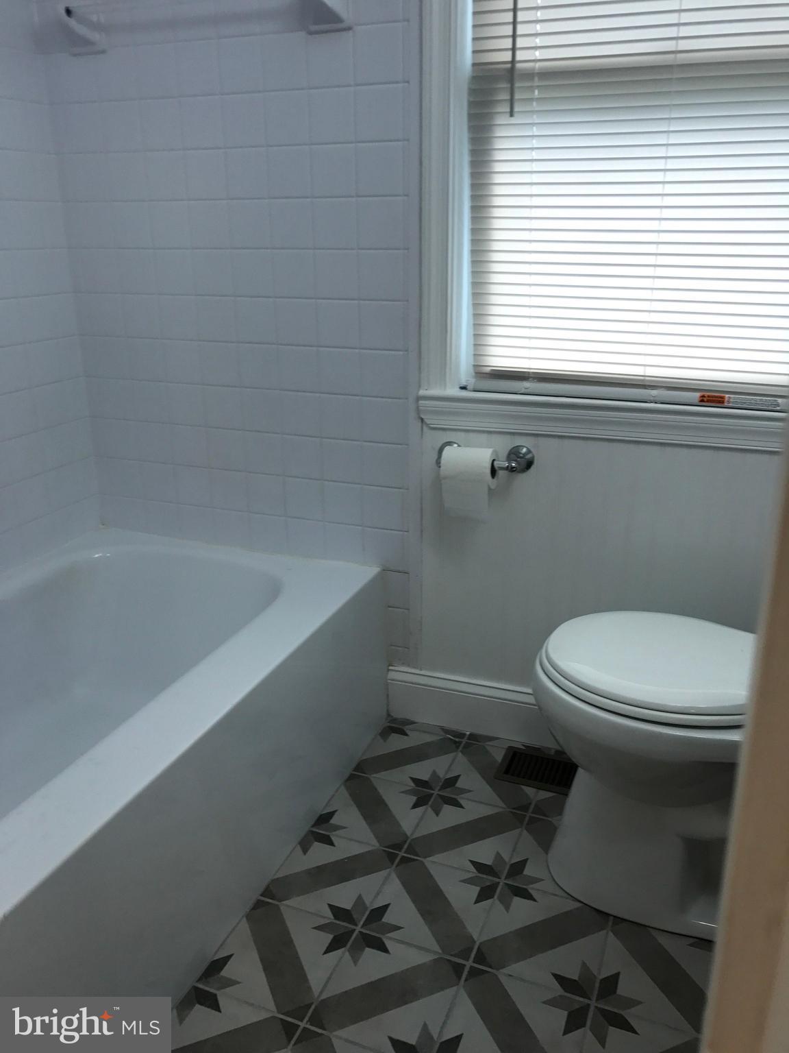 1441 Walker Avenue Baltimore, MD 21239 - Photo 24 of 28 a white toilet sitting next to a window