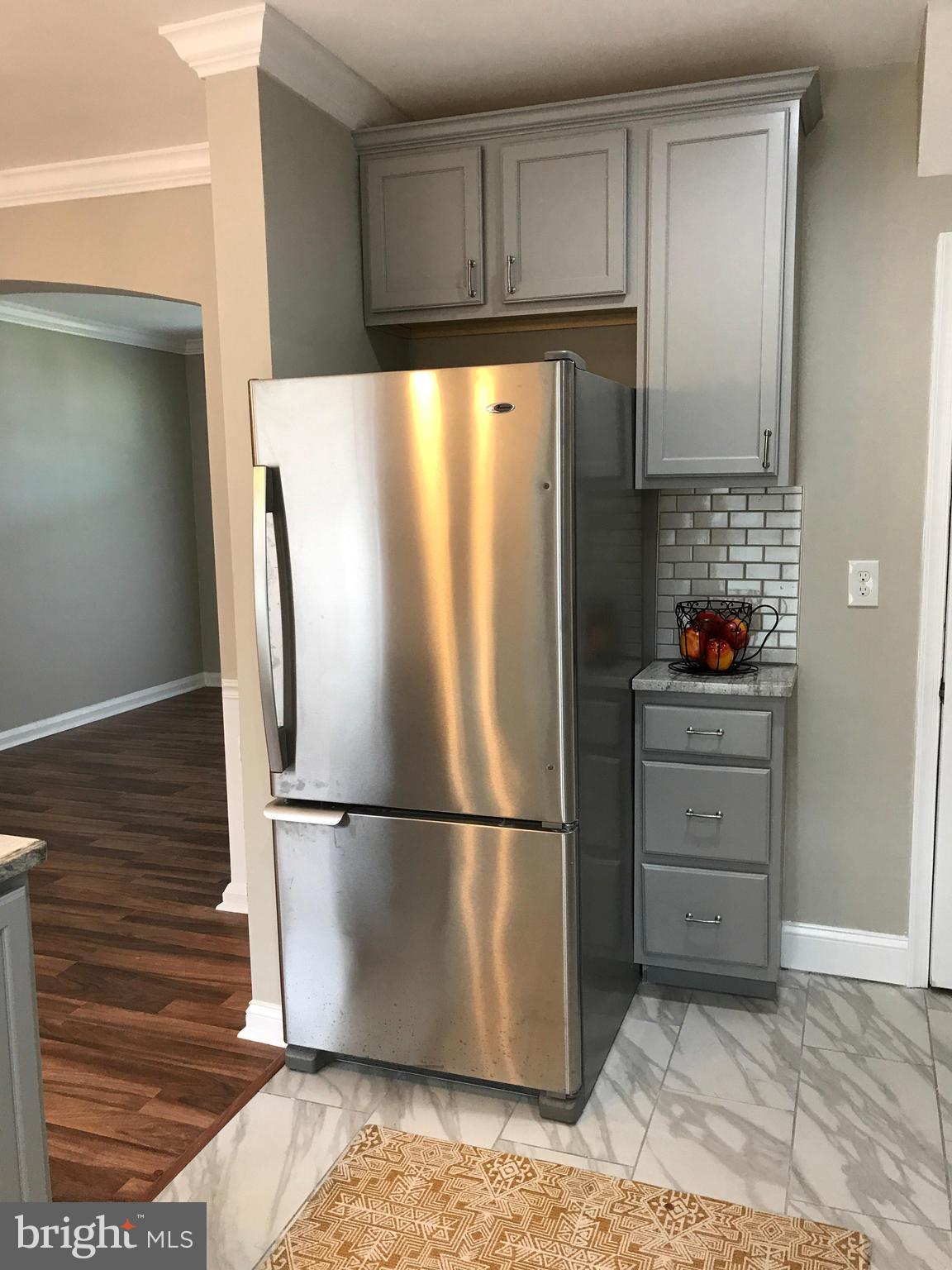 1441 Walker Avenue Baltimore, MD 21239 - Photo 4 of 28 a kitchen with appliances and cabinets