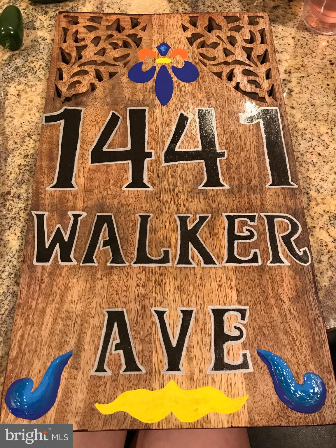 1441 Walker Avenue Baltimore, MD 21239 - Photo 6 of 28 a street sign that is on a pole