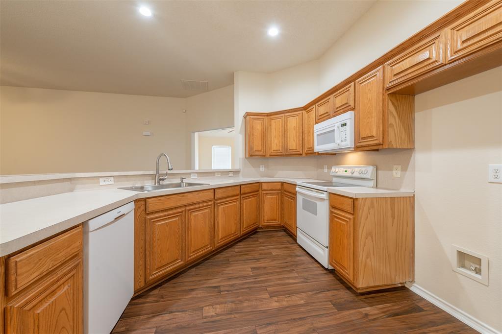 202 Whitestone Way Weatherford, TX 76085 - Photo 13 of 35 a large kitchen with stainless steel appliances granite countertop a sink and cabinets