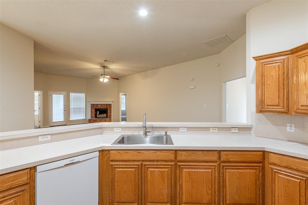 202 Whitestone Way Weatherford, TX 76085 - Photo 34 of 35 a kitchen with a sink and cabinets