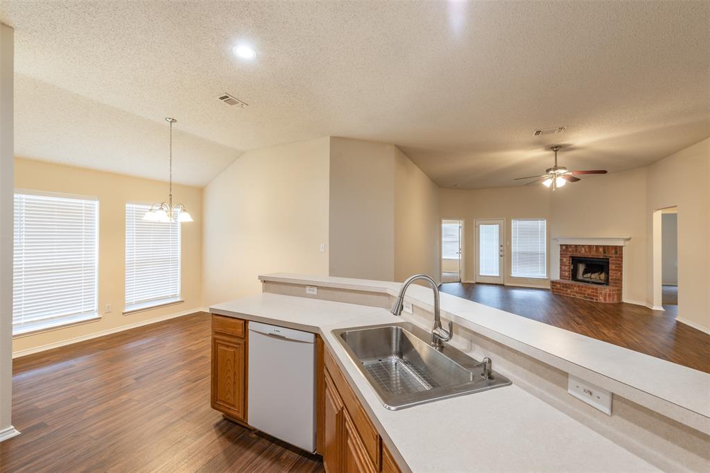 202 Whitestone Way Weatherford, TX 76085 - Photo 35 of 35 a kitchen with a sink stove and wooden floor