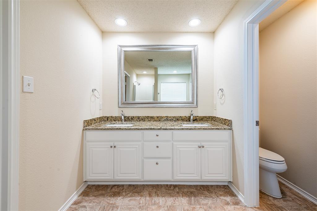 202 Whitestone Way Weatherford, TX 76085 - Photo 17 of 35 a bathroom with a granite countertop sink a toilet and a mirror