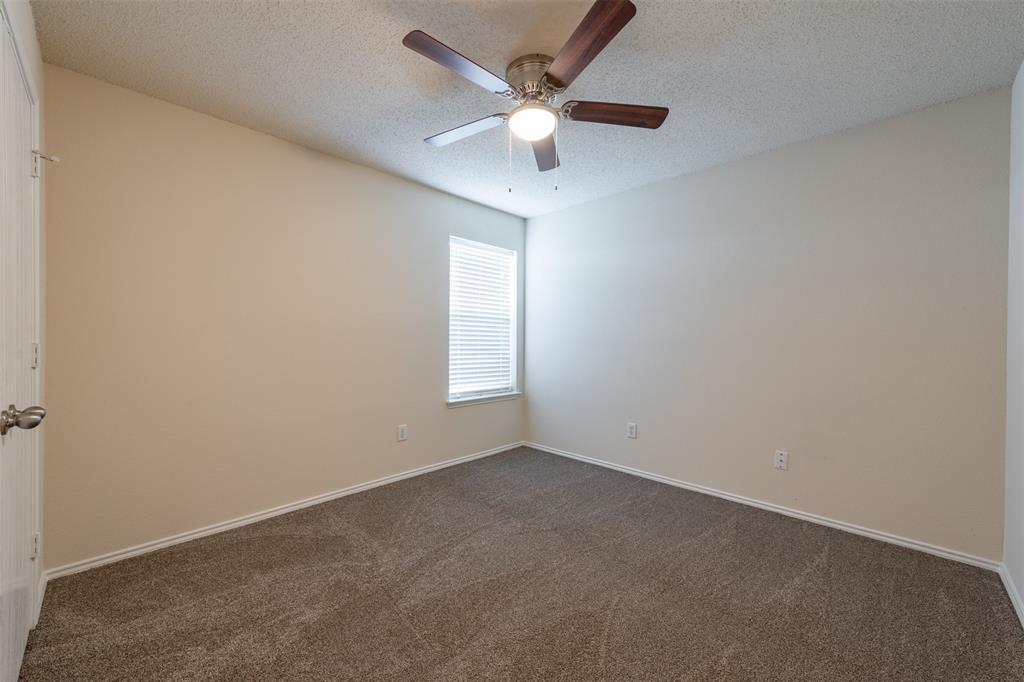 202 Whitestone Way Weatherford, TX 76085 - Photo 21 of 35 an empty room with a window and a fan