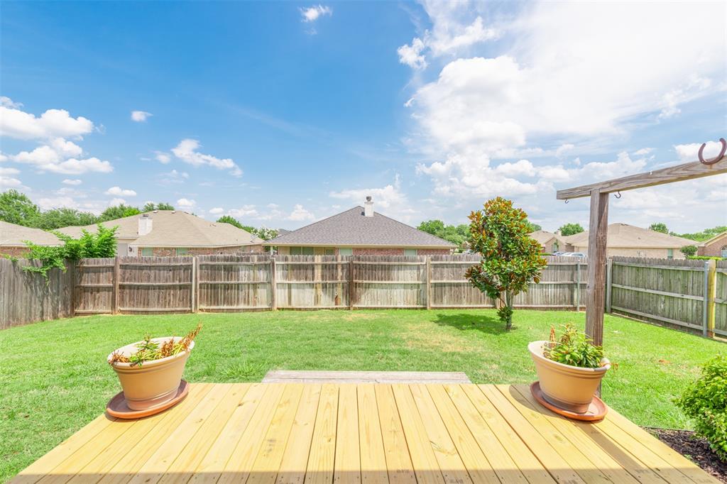 202 Whitestone Way Weatherford, TX 76085 - Photo 32 of 35 a front view of a house with a yard and potted plants