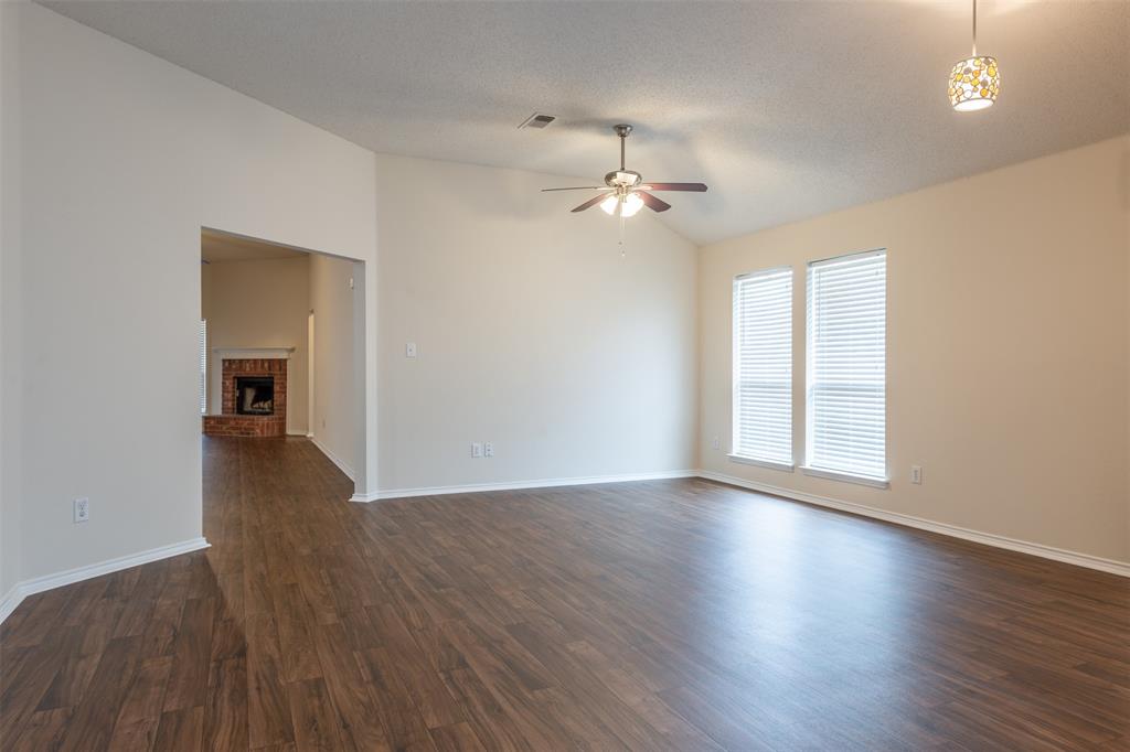 202 Whitestone Way Weatherford, TX 76085 - Photo 8 of 35 wooden floor in an empty room with a window