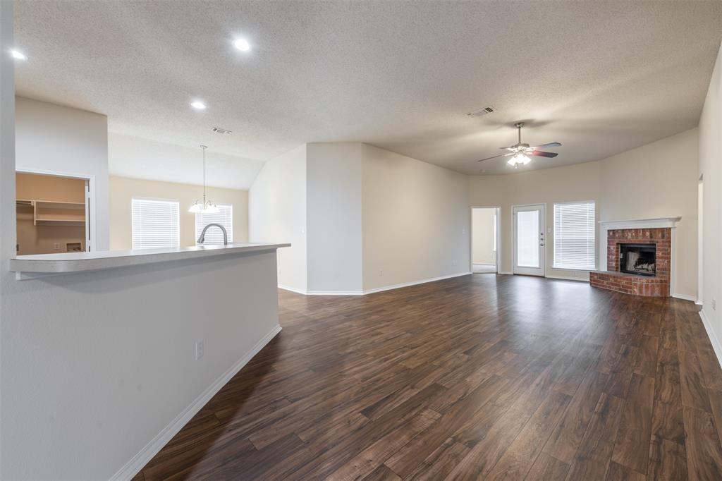 202 Whitestone Way Weatherford, TX 76085 - Photo 9 of 35 a view of a living room a kitchen with wooden floor and a kitchen