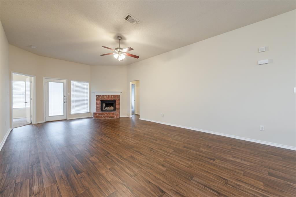 202 Whitestone Way Weatherford, TX 76085 - Photo 10 of 35 a view of a livingroom with wooden floor and a ceiling fan