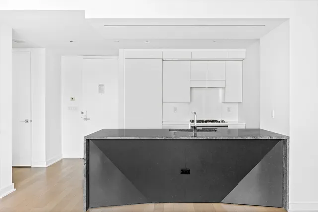 a bedroom with a large bed and a book shelf