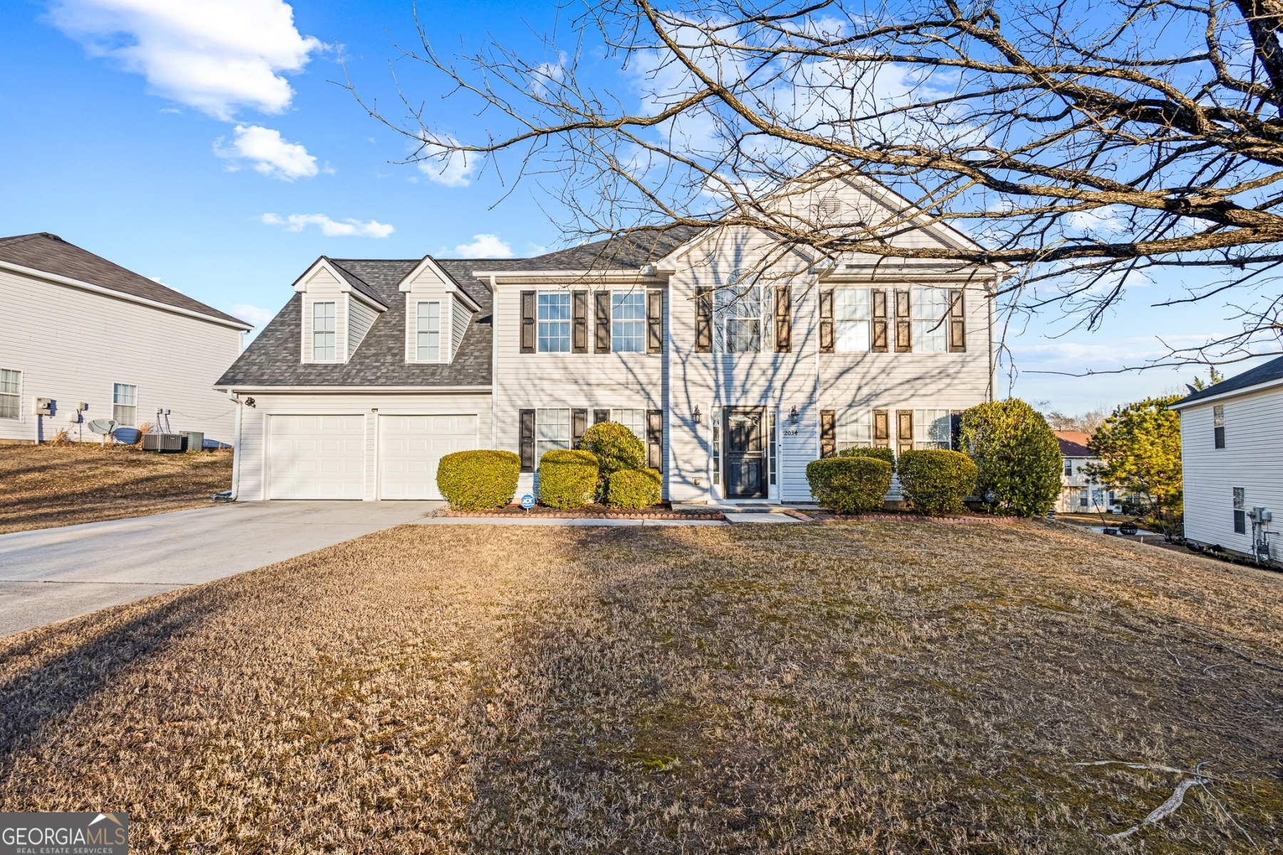 a front view of a house with a yard and garage