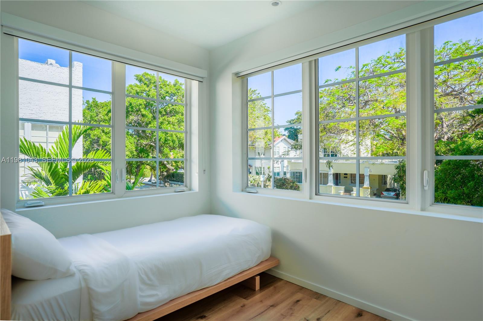 136 Northeast 46th Street, Unit 3 Miami, FL 33137 - Photo 3 of 9 a bed sitting in a bedroom next to a window