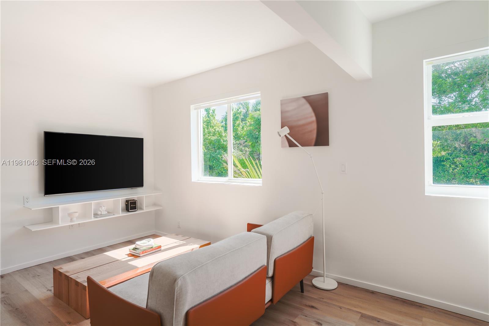 136 Northeast 46th Street, Unit 3 Miami, FL 33137 - Photo 4 of 9 a room with a bed and a flat screen tv