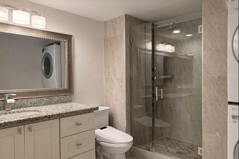 21851 Arriba Real, Unit L Boca Raton, FL 33433 - Photo 21 of 26 a bathroom with a granite countertop sink a toilet and shower