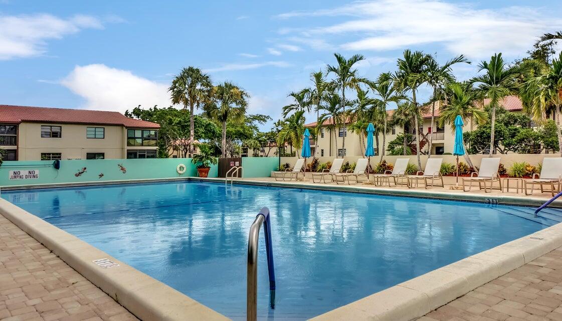 21851 Arriba Real, Unit L Boca Raton, FL 33433 - Photo 23 of 26 a view of a swimming pool with a yard