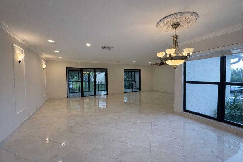 21851 Arriba Real, Unit L Boca Raton, FL 33433 - Photo 6 of 26 a view of an empty room with a chandelier