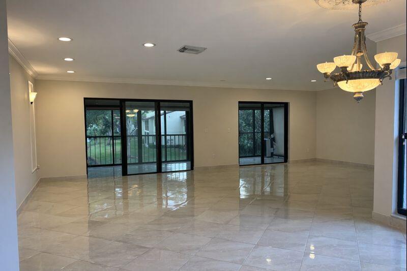 21851 Arriba Real, Unit L Boca Raton, FL 33433 - Photo 7 of 26 a view of an entryway with a chandelier