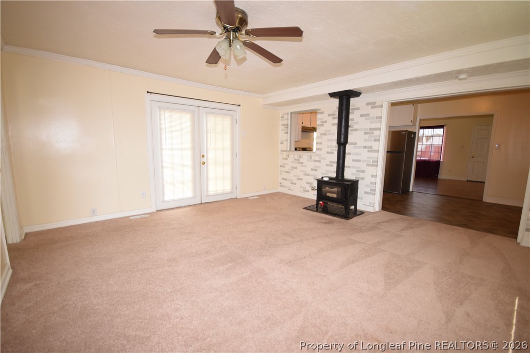 108 South 6th Street Spring Lake, NC 28390 - Photo 12 of 20 a bedroom with a bed and a chandelier