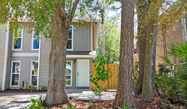 a front view of a house with trees