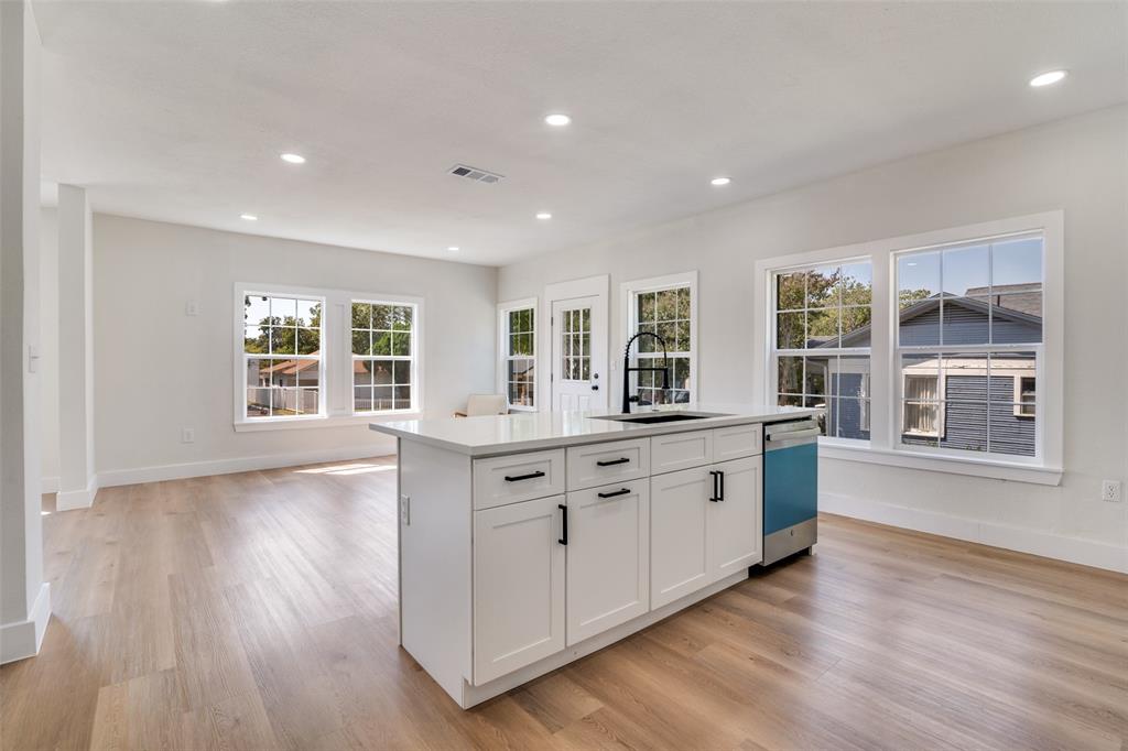 718 Grandview Avenue Dallas, TX 75223 - Photo 12 of 26 a large kitchen with stainless steel appliances granite countertop a large window a sink and a oven