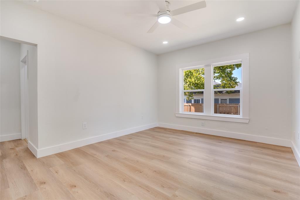 718 Grandview Avenue Dallas, TX 75223 - Photo 18 of 26 an empty room with wooden floor and windows