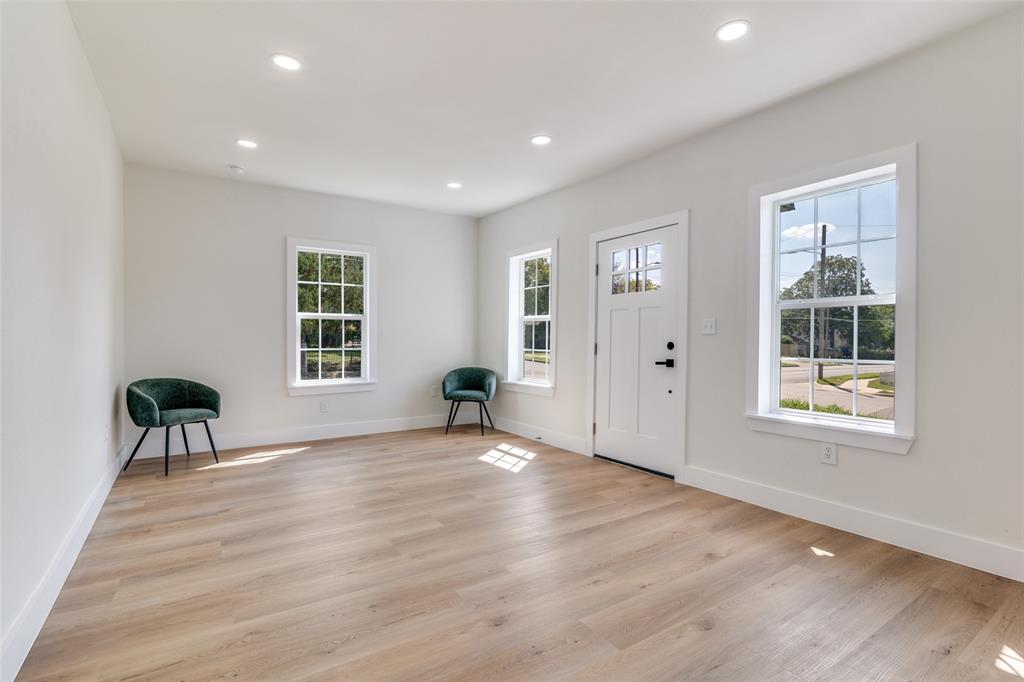 718 Grandview Avenue Dallas, TX 75223 - Photo 5 of 26 an empty room with wooden floor and windows