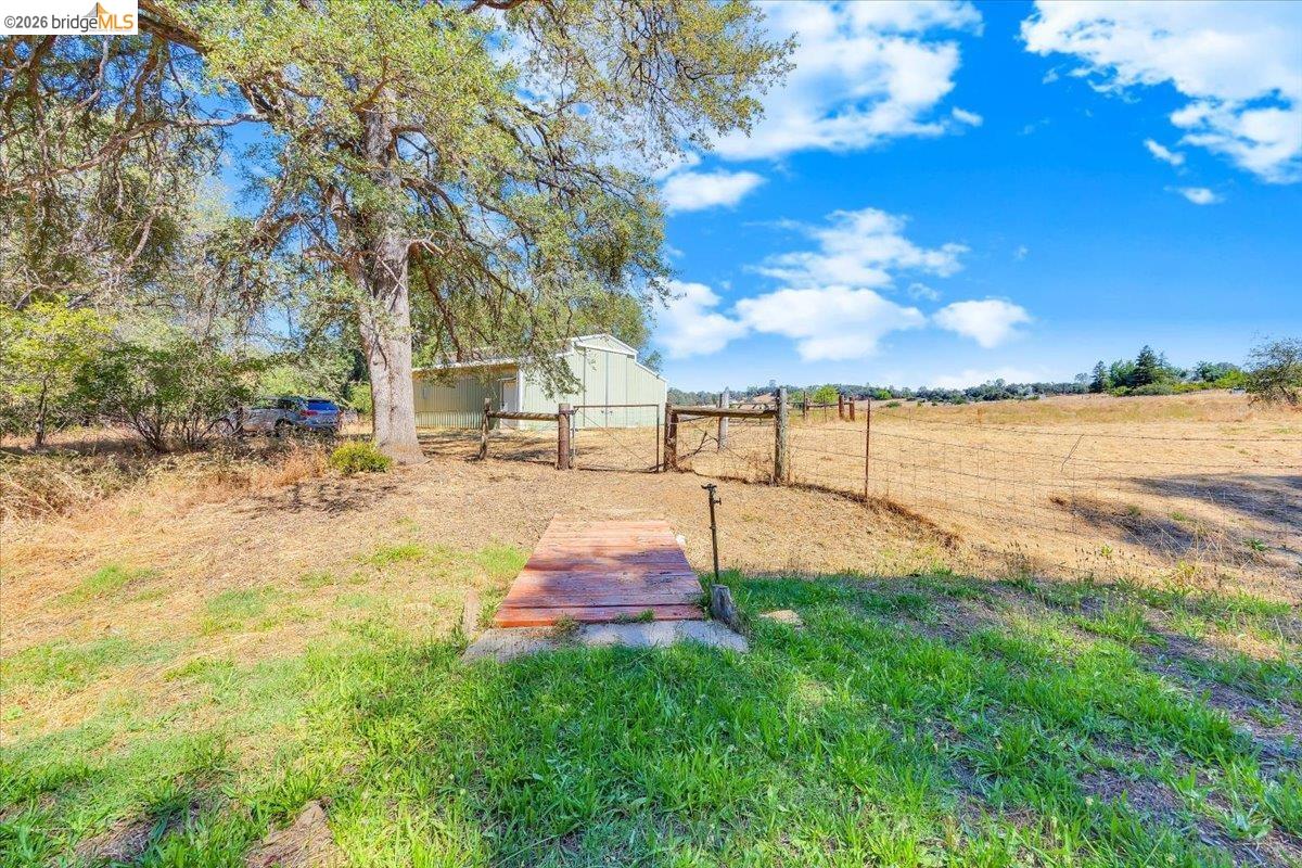 8733 Fraguero Road Sonora, CA 95370 - Photo 72 of 73 Expansive outdoor area featuring a mature tree, open fields, and a utility building