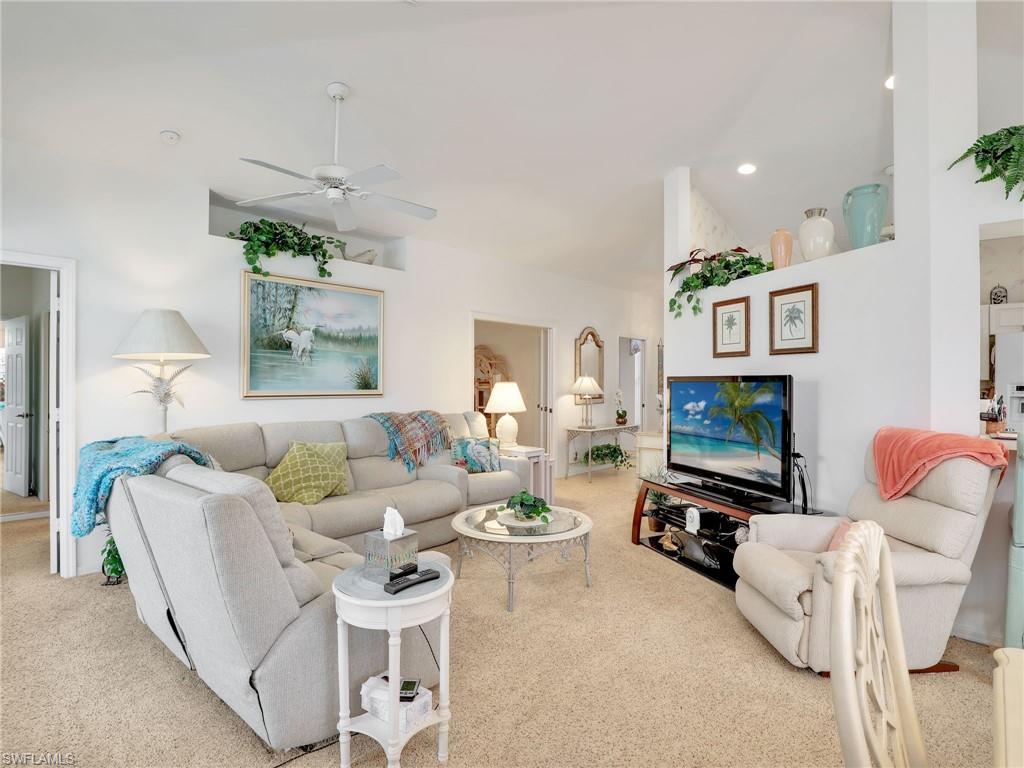 586 Crossfield Circle Naples, FL 34104 - Photo 11 of 38 a living room with furniture and a flat screen tv