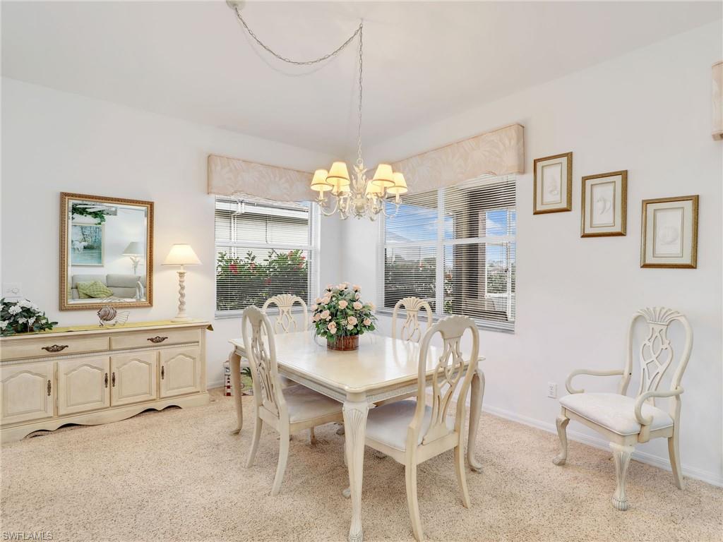 586 Crossfield Circle Naples, FL 34104 - Photo 12 of 38 a view of a dining room with furniture and chandelier