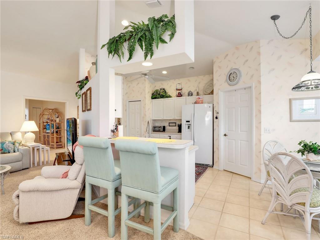 586 Crossfield Circle Naples, FL 34104 - Photo 16 of 38 a dining room with furniture and a large mirror