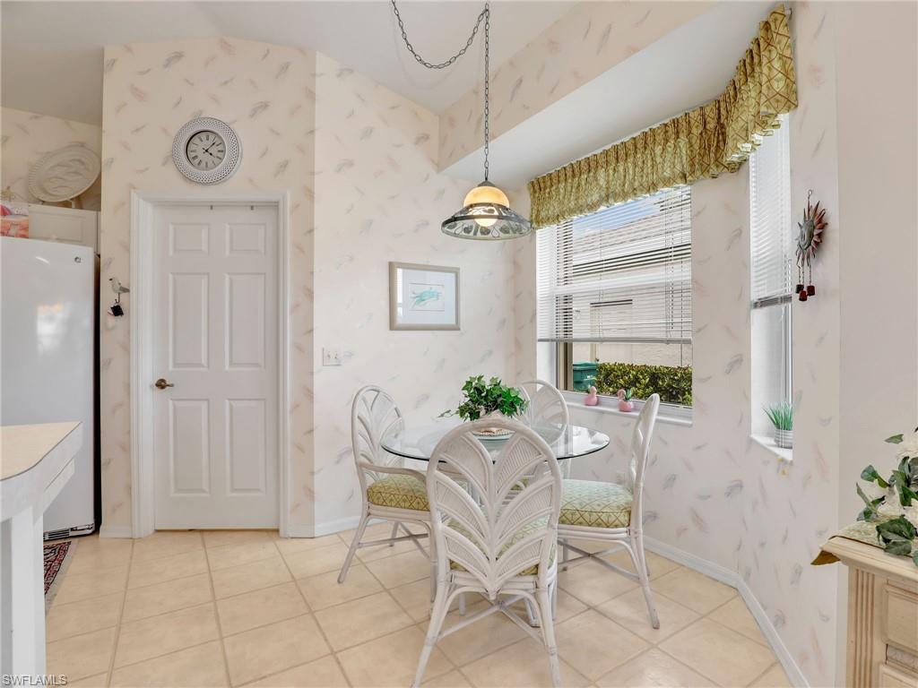 586 Crossfield Circle Naples, FL 34104 - Photo 17 of 38 a view of a dining room with furniture and a chandelier