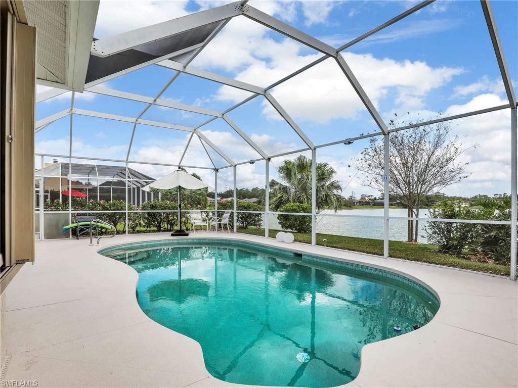 586 Crossfield Circle Naples, FL 34104 - Photo 2 of 38 a view of a swimming pool with a patio